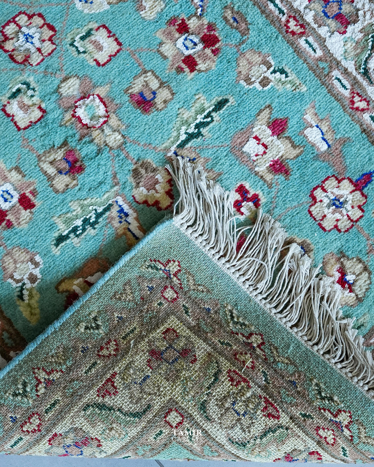 Folded corner showing the back weave and fringe of the single-knotted runner