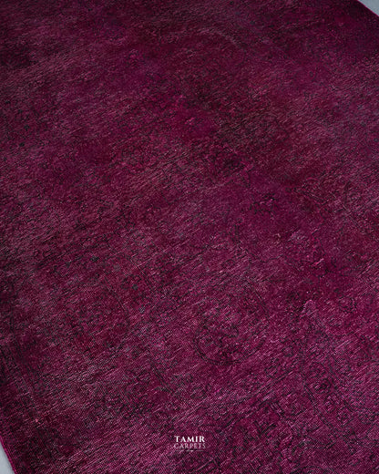 Magenta overdyed field showing traces of the original Afghan design